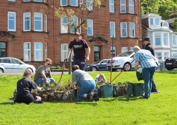 The group of volunteers who make up the Incredible Edible Bute group, working hard at Battery Place.