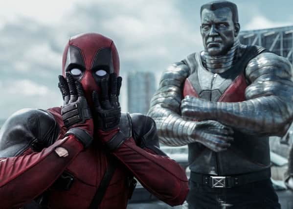 Deadpool (Ryan Reynolds) reacts to a threat from Colossus (voiced by Stefan Kapicic)