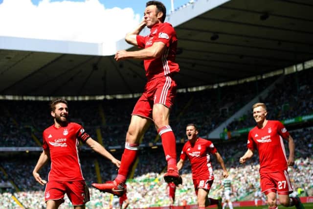 Andrew Considine celebrates his winning goal at Celtic Park as Aberdeen confirm second place. Picture: SNS