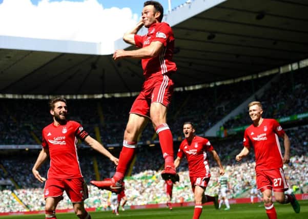 Andrew Considine celebrates his winning goal at Celtic Park as Aberdeen confirm second place. Picture: SNS
