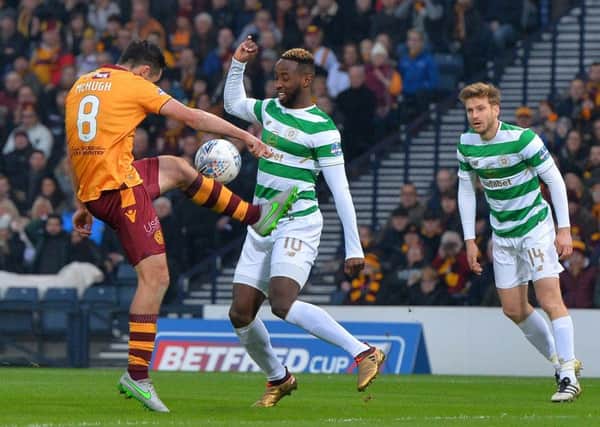 Celtic striker Moussa Dembele is tackled by Carl McHugh of Motherwell during the League Cup final at Hampden in November. Picture: Getty.
