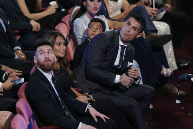 Lionel Messi, left, and Cristiano Ronaldo. Were as different at Ferrari and Porsche said Ronaldo.  Photograph: Rex/Shutterstock