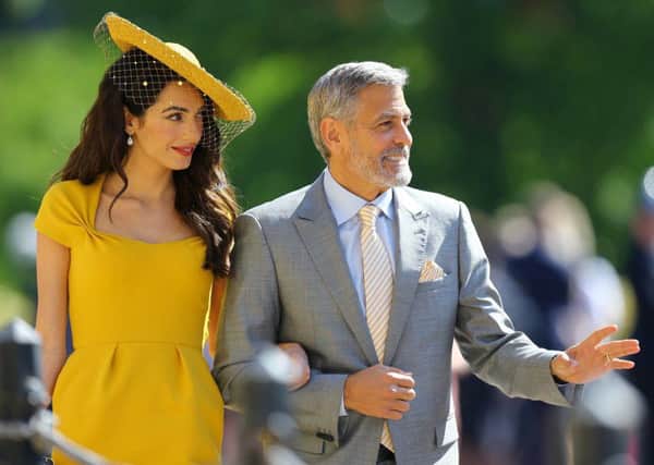 Amal Clooney and George Clooney arrive at St George's Chapel.