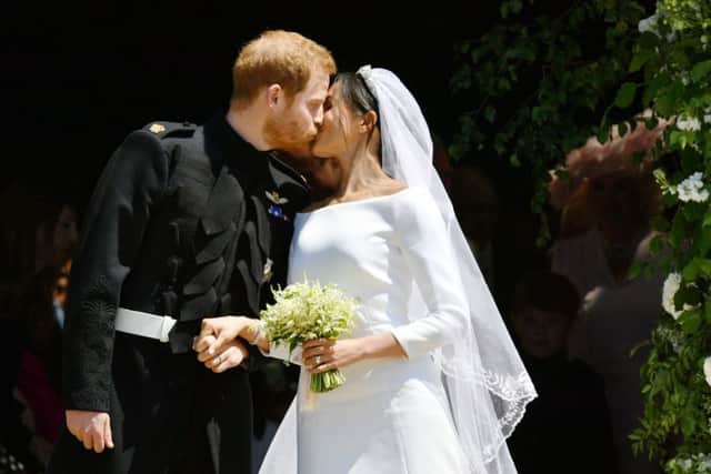 Britain's Prince Harry, Duke of Sussex kisses his wife Meghan, Duchess of Sussex. Picture: AFP