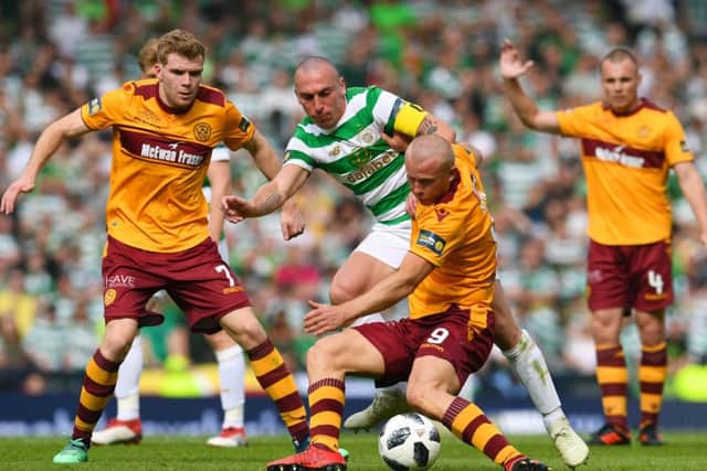 Celtic's Scott Brown competes with Motherwell's Curtis Main. Picture: SNS/Craig Foy