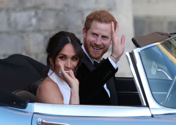 The newly married Duke and Duchess of Sussex, Meghan Markle and Prince Harry, leaving Windsor Castle to attend an evening reception at Frogmore House. Picture: Steve Parsons/PA Wire