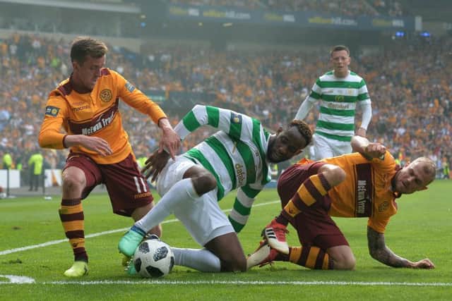 Moussa Dembele is tackled by Motherwell's Richard Tait and Elliott Frear. Picture: Mark Runnacles/Getty