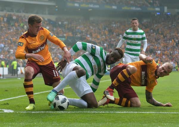 Moussa Dembele is tackled by Motherwell's Richard Tait and Elliott Frear. Picture: Mark Runnacles/Getty