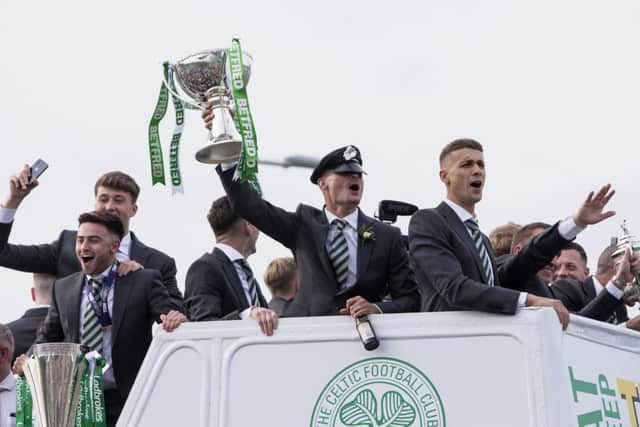 Celtic's Mikael Lustig celebrates on the open top bus. Picture: SNS/Bruce White