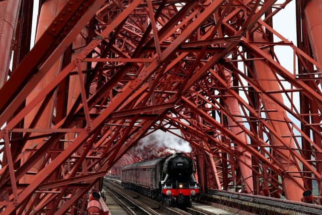 The Flying Scotsman steam train crosses the Forth Rail Bridge as it tours the country. Picture: Andrew Milligan/PA