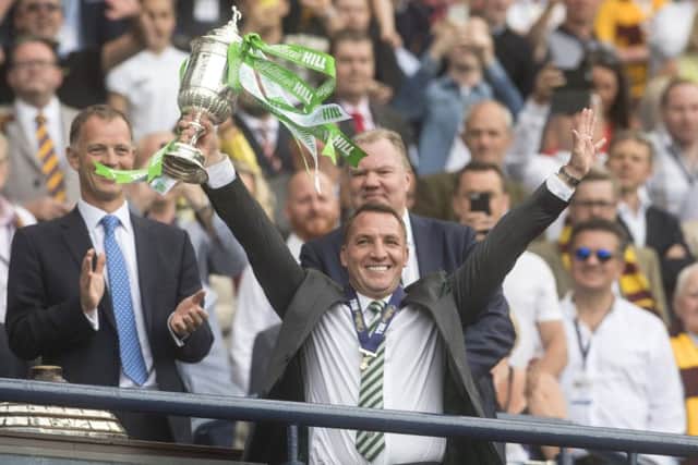 Brendan Rodgers holds aloft the Scottish Cup following Saturdays comfortable win against Motherwell. Caption: John Devlin.