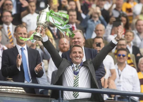 Brendan Rodgers holds aloft the Scottish Cup following Saturdays comfortable win against Motherwell. Caption: John Devlin.