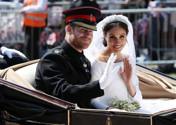Prince Harry, Duke of Sussex and Meghan, Duchess of Sussex wave from the Ascot Landau Carriage during their carriage procession on Castle Hill. Picture: Aaron Chown - WPA Pool/Getty Images