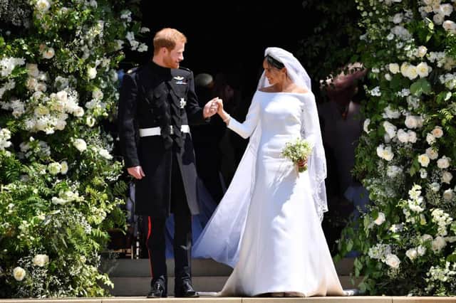 Prince Harry and his wife Meghan emerge from the West Door of St George's Chapel, Windsor Castle (Picture: AFP/Getty Images)