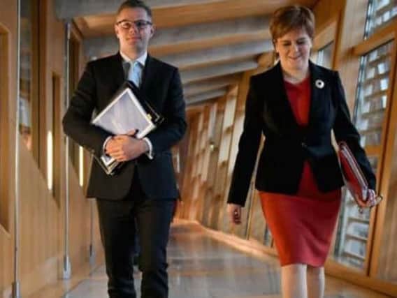 Finance Secretary Derek Mackay, with Nicola Sturgeon, bowed to demands for extra cash for councils in this year's budget