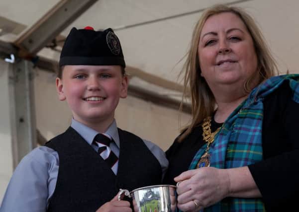 Rothesay & District Pipe Band's Olivia  receives the third place trophy at the British championships held in Paisley. Photo by David Cameron.