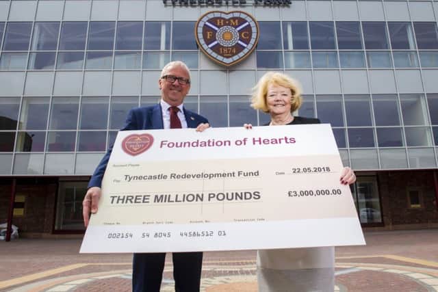 Foundation of Hearts chairman Stuart Wallace presents Ann Budge with a £3m cheque towards the Tynecastle Stadium Redevelopment. Picture: SNS.