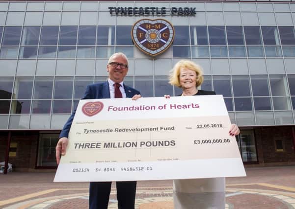 Foundation of Hearts chairman Stuart Wallace presents Ann Budge with a £3m cheque towards the Tynecastle Stadium Redevelopment. Picture: SNS.