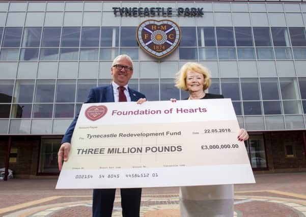 Foundation of Hearts chairman Stuart Wallace  presents Ann Budge with a Â£3m cheque towards the Tynecastle Stadium Redevelopment. Picture: SNS.