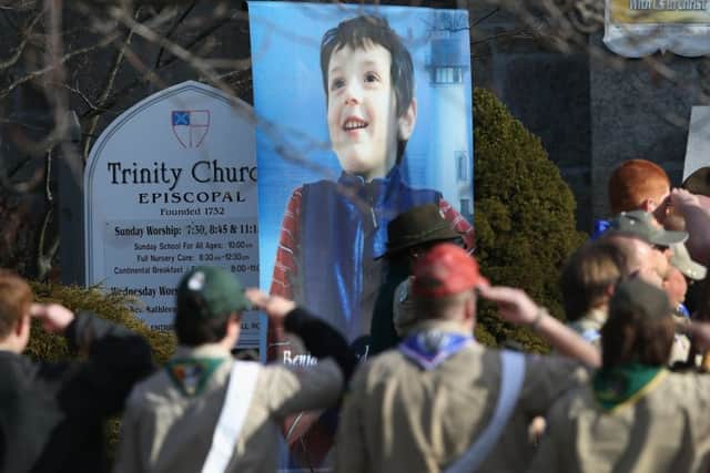 NEWTOWN, CT - DECEMBER 20:  Boy scouts salute as a funeral procession for Benjamin Wheeler, 6, enters the Trinity Episcopal Church on December 20, 2012 in Newtown, Connecticut. Benjamin, a member of Tiger Scout Den 6, was killed when 20 children and six adults were massacred at Sandy Hook Elementary School last Friday.  (Photo by John Moore/Getty Images)