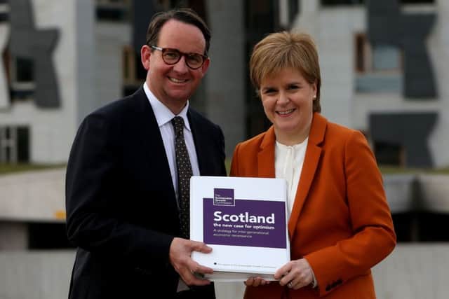 First Minister Nicola Sturgeon receives the Sustainable Growth Commission report from commission chair Andrew Wilson. Picture: Gordon Terris/The Herald/PA Wire