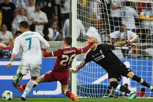 Andy Robertson makes a saving tackle to stop Cristiano Ronaldo from scoring. Photograph: Paul Ellis/AFP/Getty