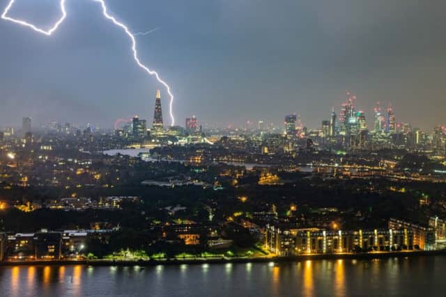 A dramatic bolt of lightning lights up the sky above The Shard, London on Saturday night. Picture: SWNS