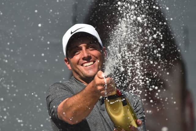Francesco Molinari sprays the champagne after winning his first BMW PGA Championship, a year after finishing second. Picture: Getty.