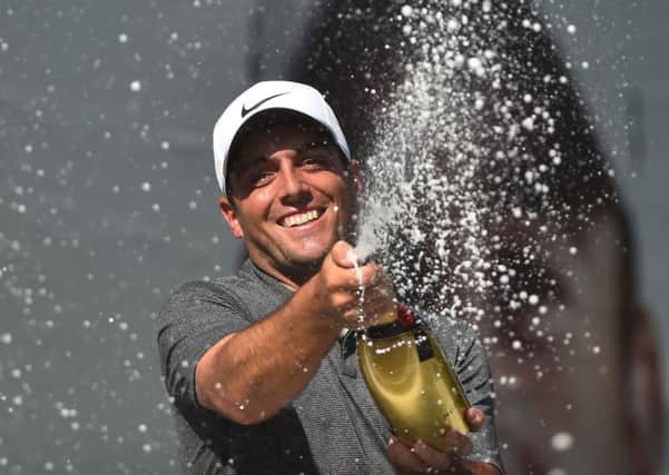 Francesco Molinari sprays the champagne after winning his first BMW PGA Championship, a year after finishing second. Picture: Getty.