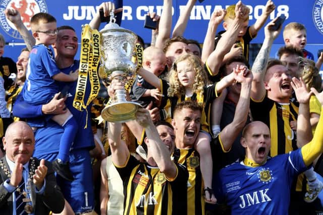 Gordon Pope lifts the trophy for Auchinleck after a dramatic finish to the Scottish Junior Cup final at Rugby Park. Picture: SNS.