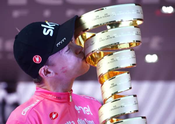 Chris Froomer kisses the trophy on the podium in Rome. Picture: AFP/Getty.