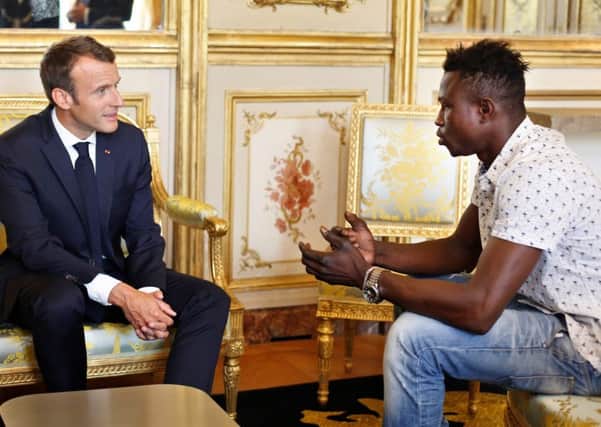 French President Emmanuel Macron speaks with Mamoudou Gassama, 22, at the presidential Elysee Palace in Paris (Picture: AFP/Getty Images)