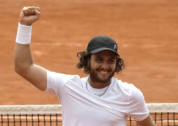 Argentina's Marco Trungelliti raises his fist in victory after defeating Australia's Bernard Tomic at the French Open. Picture: Alessandra Tarantino/AP