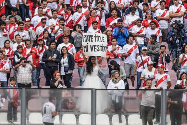 The Estadio Nacional del Peru  was sold out for a Peru training session on Sunday when, main picture, a female fan proposed marriage to national coach Ricardo Gareca.