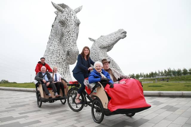 Public health minister Aileen Campbell takes Mary Duncan, 90, and Jim Taylor, 96, for a spin at the Kelpies in Falkirk. Picture by Stewart Attwood