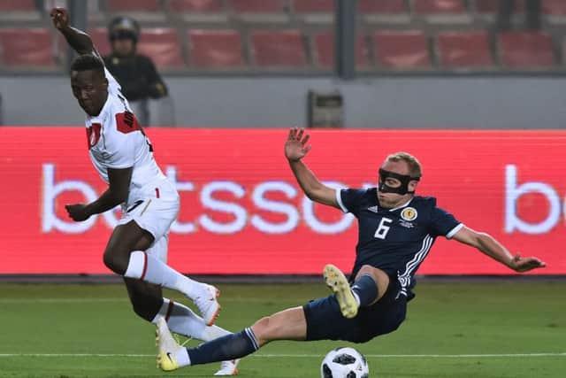 Dylan McGeouch challenges Luis Advincula for the ball. Picture: Cris Bouroncle/AFP/Getty