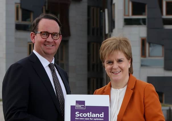 Andrew Wilson and Nicola Sturgeon with the Growth Commission report. It avoided making the sort of claims of instant Utopia which seriously undermined the independence campaign in 2014. Photograph: PA
