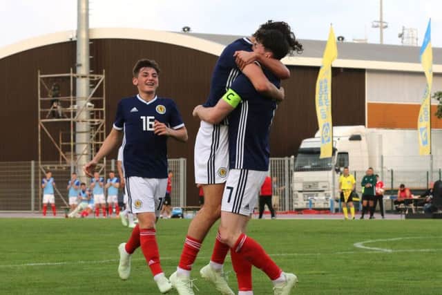 Oliver Burke celebrates scoring Scotland's goal with Fraser Hornby. Picture: TGSPhoto/REX/Shutterstock