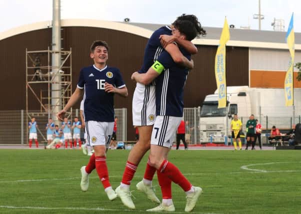 Oliver Burke celebrates scoring Scotland's goal with Fraser Hornby. Picture: TGSPhoto/REX/Shutterstock