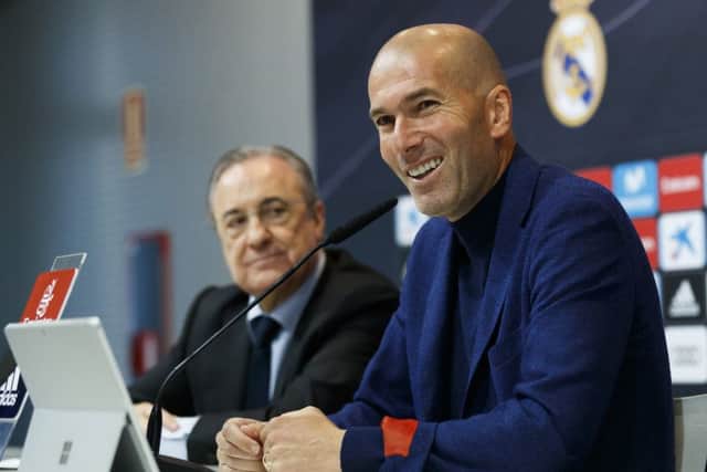 Zinedine Zidane, flanked by club president Florentino Perez, announces his departure from Real Madrid yesterday. Picture: Real Madrid via Getty.