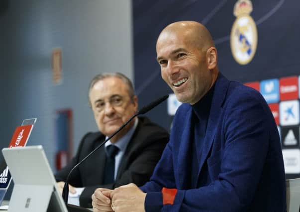 Zinedine Zidane, flanked by club president Florentino Perez, announces his departure from Real Madrid yesterday. Picture: Real Madrid via Getty.