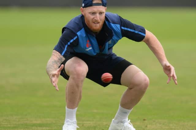 Ben Stokes, with strapping on his hamstring, bends down to catch a ball in training. Picture: Getty.