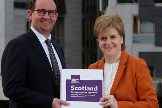 First Minister Nicola Sturgeon receives the Sustainable Growth Commission report from commission chair Andrew Wilson