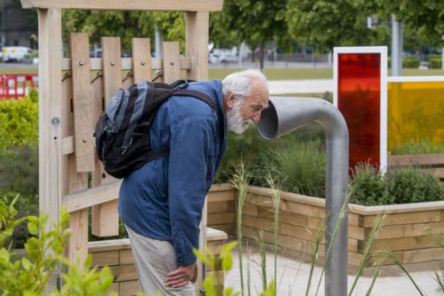 A man listens out in the Sensory Garden at Slessor Gardens. Picture: John Devlin