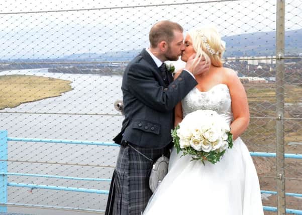 Kate and Barry Elliot tied to knot at the top of the Titan crane on the banks of the River Clyde. Picture: SWNS