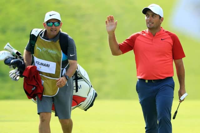 Francesco Molinari acknowledges the crowd after putting a birdie on the 18th hole during the third round of the Italian Open. Photograph: Andrew Redington/Getty