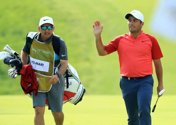 Francesco Molinari acknowledges the crowd after putting a birdie on the 18th hole during the third round of the Italian Open. Photograph: Andrew Redington/Getty