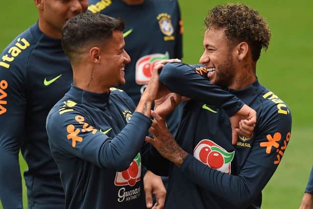 Brazil striker Neymar, right, larks about with Philippe Coutinho in training. Picture: Oli Scarff/AFP/Getty.