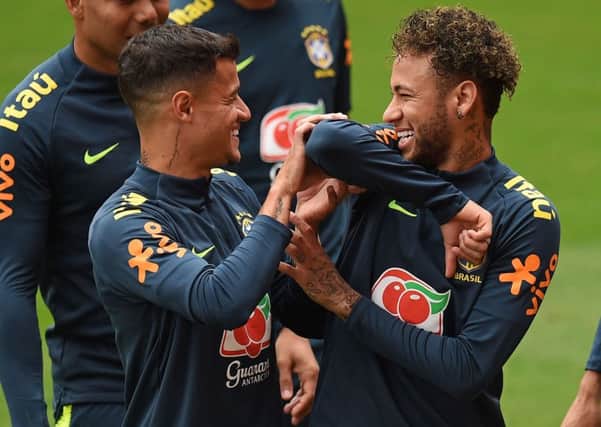 Brazil striker Neymar, right, larks about with Philippe Coutinho in training. Picture: Oli Scarff/AFP/Getty.