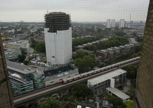 Scaffolding covers the burnt out Grenfell Tower. Picture; AP